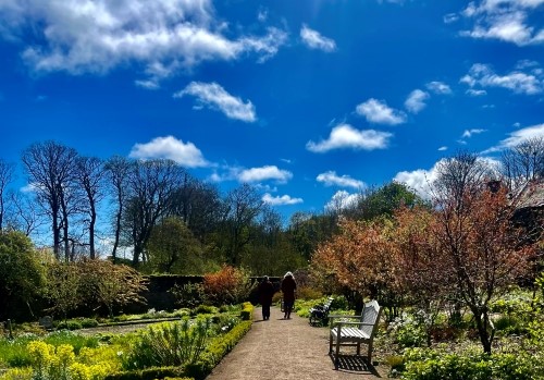 2 people strolling around Cambo Gardens